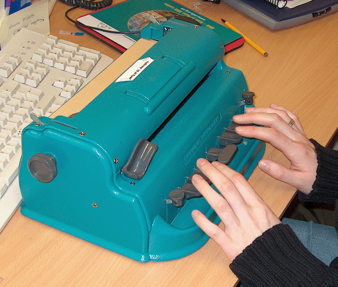 Using a Perkins Brailler. Click on image to enlarge.
